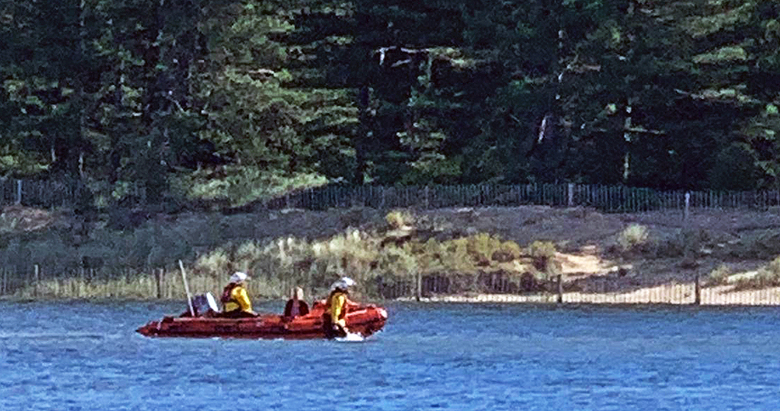 Inshore lifeboat in shallow water, landing a person cut off on the dunes on Holkham beach, 23/8/20