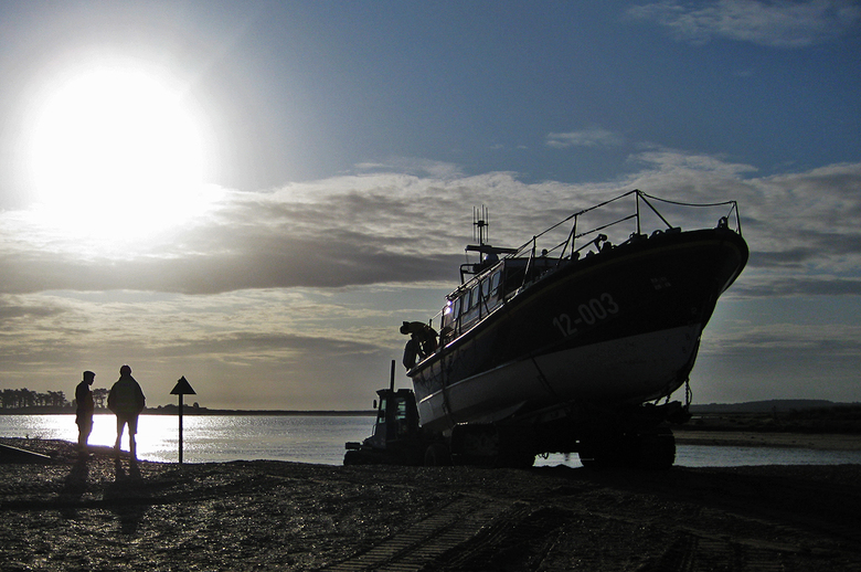 Coxswain and shore crew look on as the lifeboat is rehoused after the service to the yacht 'Phaedra'