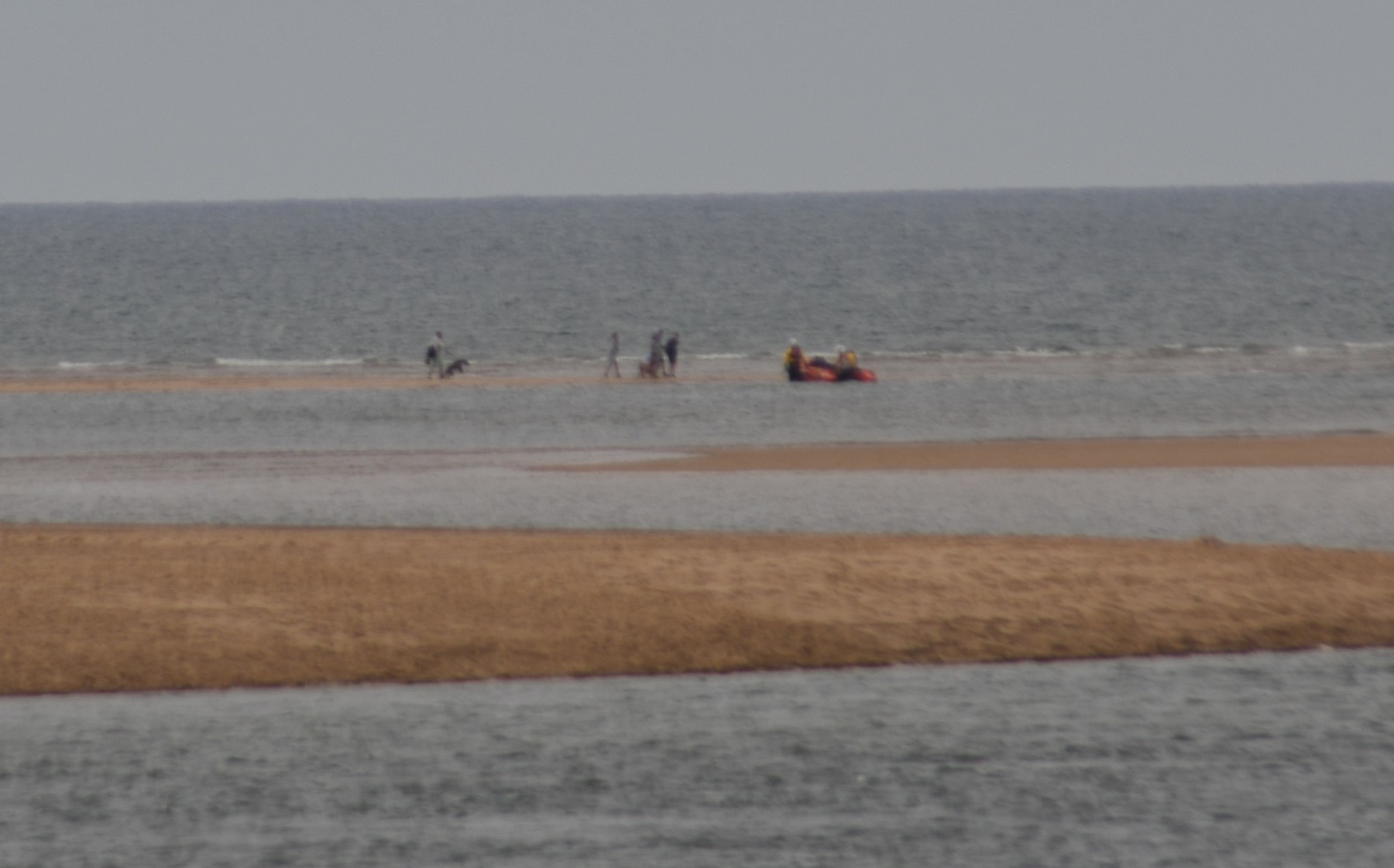 People and dogs being picked up from the sandbar to the west of the harbour entrance on the incoming tide