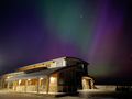 Wells boathouse with northern lights visible overhead and to the west and south