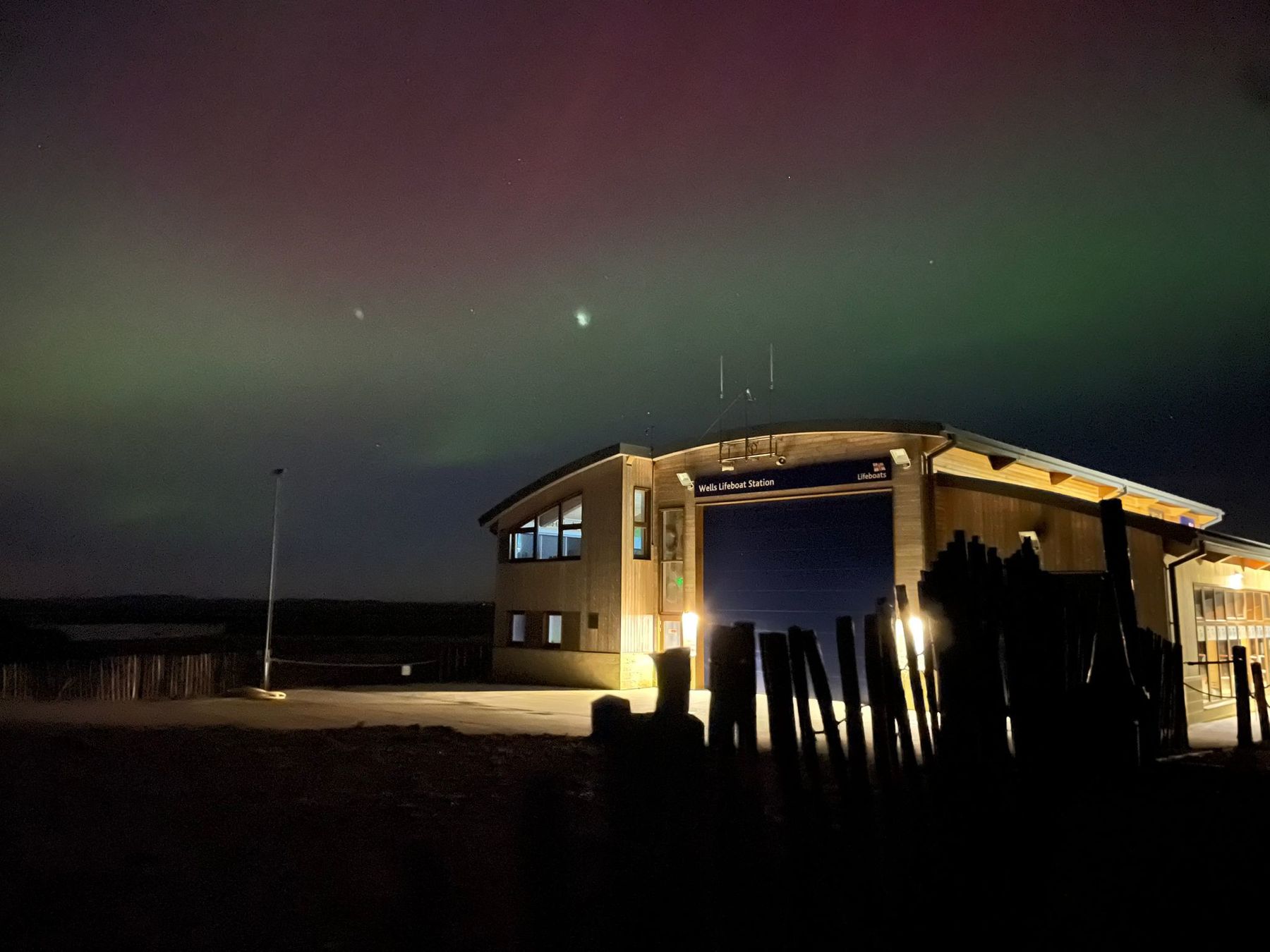 Wells boathouse with aurora visible overhead and to the south