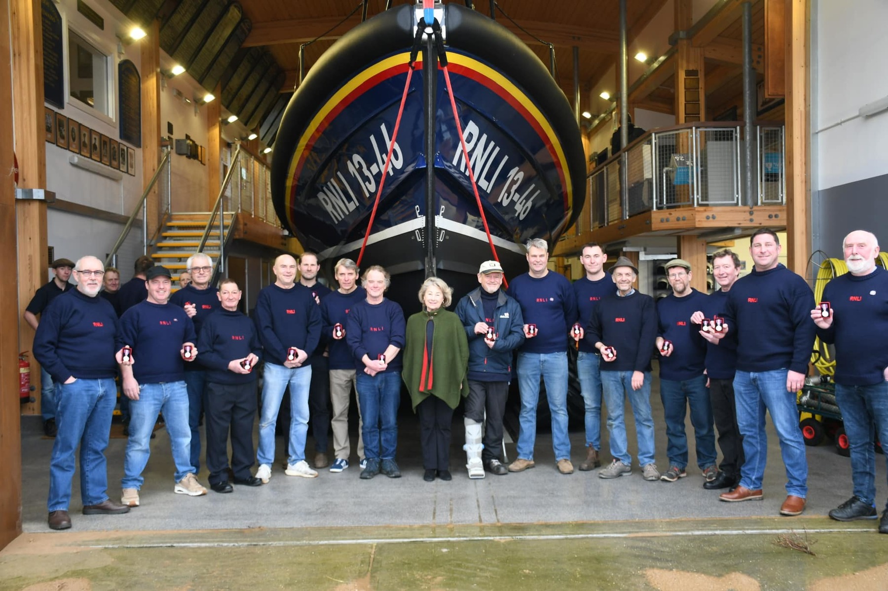 Sarah, Countess of Leicester presents crew with their Coronation medals